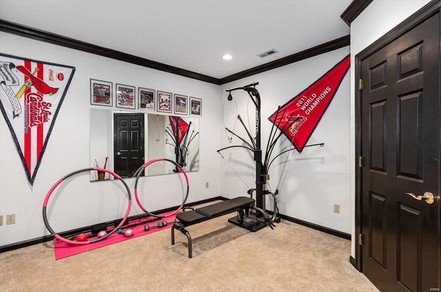 exercise area with ornamental molding and light colored carpet