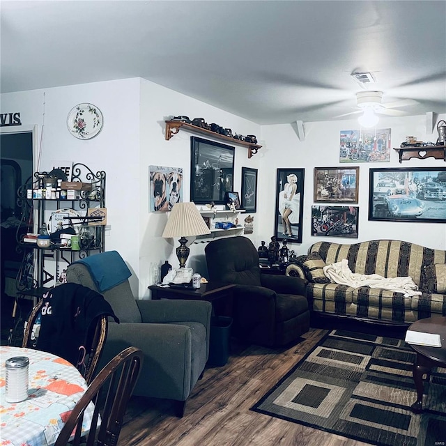 living room featuring ceiling fan and dark hardwood / wood-style flooring