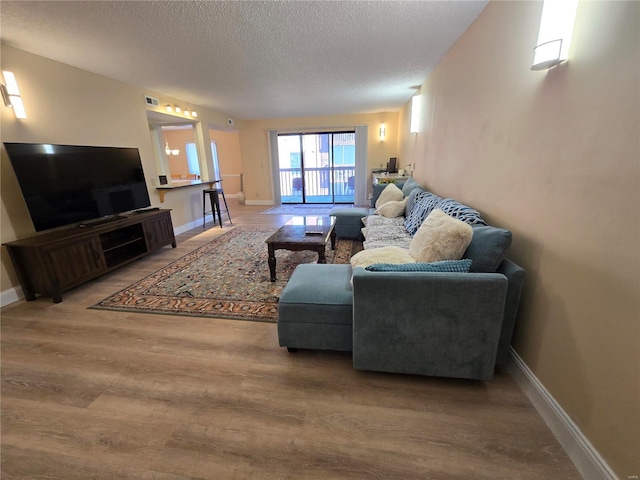 living room featuring hardwood / wood-style floors and a textured ceiling