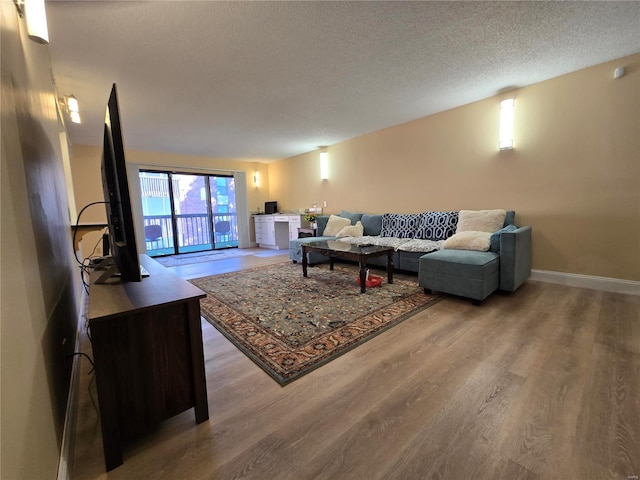 living room featuring hardwood / wood-style flooring and a textured ceiling