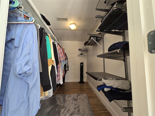 spacious closet featuring dark hardwood / wood-style floors