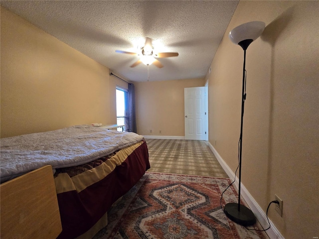 bedroom featuring carpet, a textured ceiling, and ceiling fan