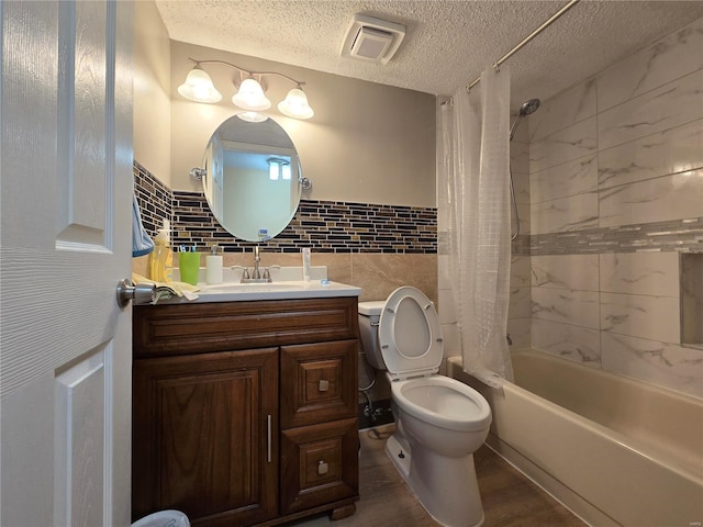 full bathroom with wood-type flooring, toilet, tile walls, vanity, and shower / tub combo with curtain