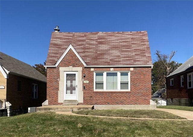 view of front facade with central AC unit and a front lawn