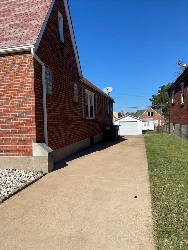 view of side of property featuring an outbuilding, a yard, and a garage