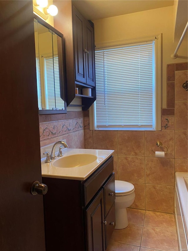 full bathroom featuring tile patterned flooring, tile walls, toilet, vanity, and shower / bathtub combination