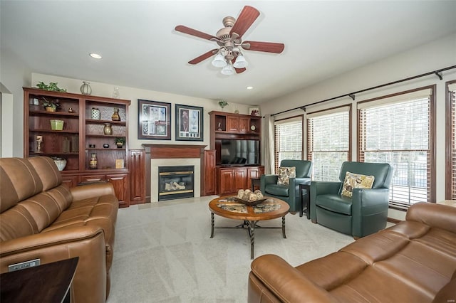 carpeted living room featuring ceiling fan