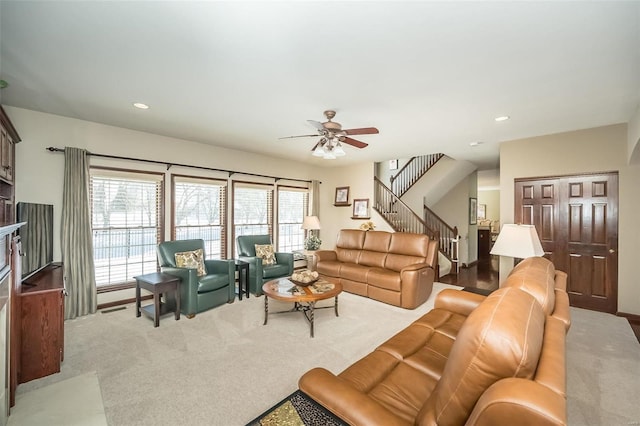 living room featuring light carpet and ceiling fan