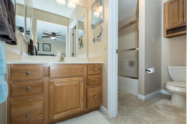 full bathroom with tile patterned floors, vanity, ceiling fan, enclosed tub / shower combo, and toilet