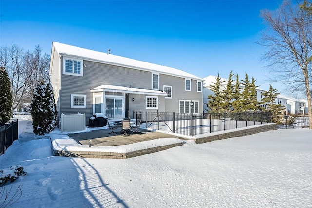 snow covered property featuring central AC