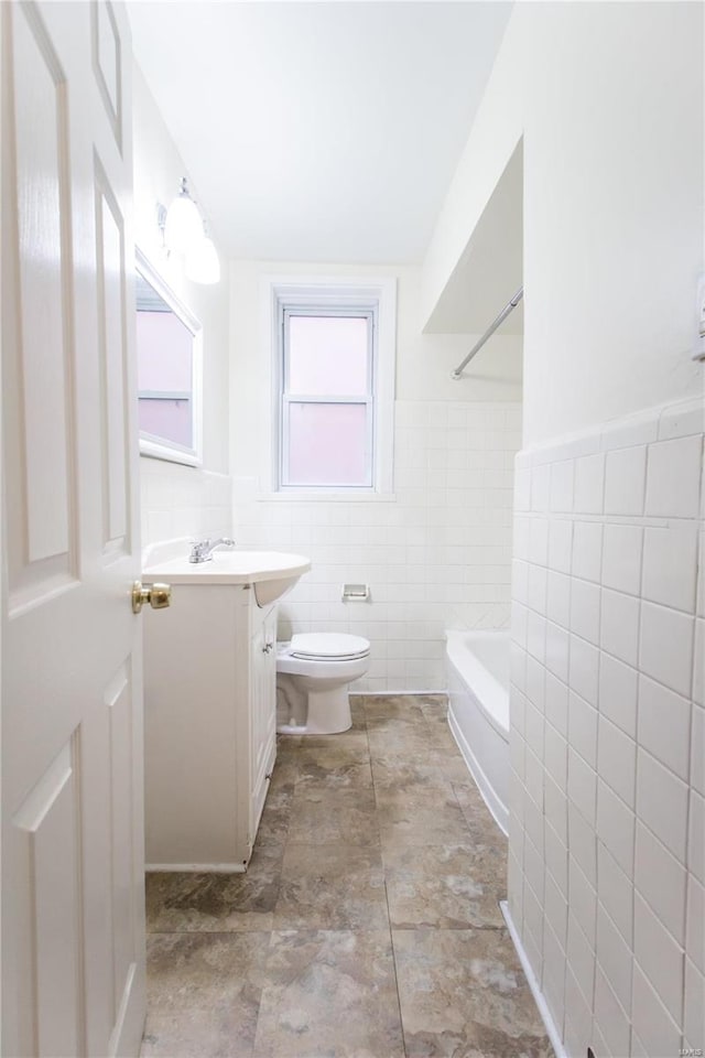 full bathroom with vanity, toilet, shower / bath combination, and tile walls