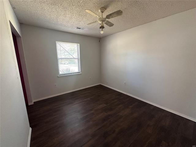 unfurnished room featuring ceiling fan, a textured ceiling, and dark hardwood / wood-style floors