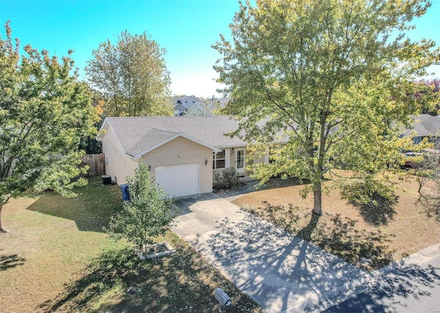 view of front of home with central air condition unit, a front lawn, and a garage