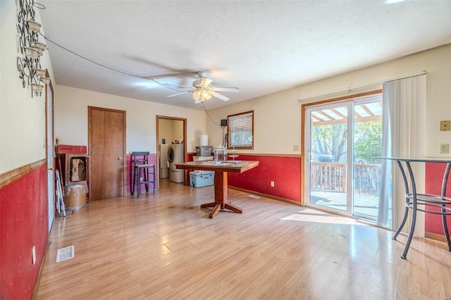 interior space featuring washer / dryer, light hardwood / wood-style floors, a textured ceiling, and ceiling fan