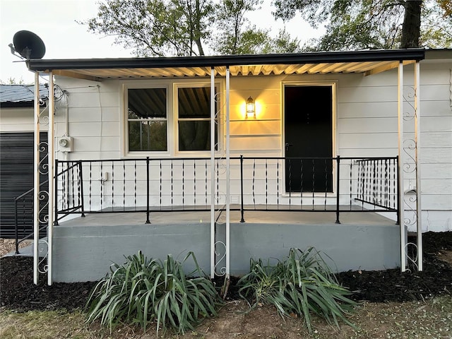 view of exterior entry with a porch