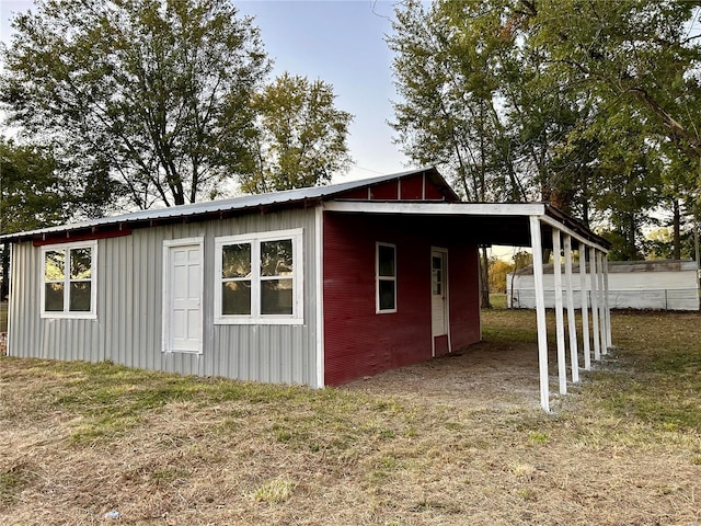 view of outbuilding with a yard and a carport