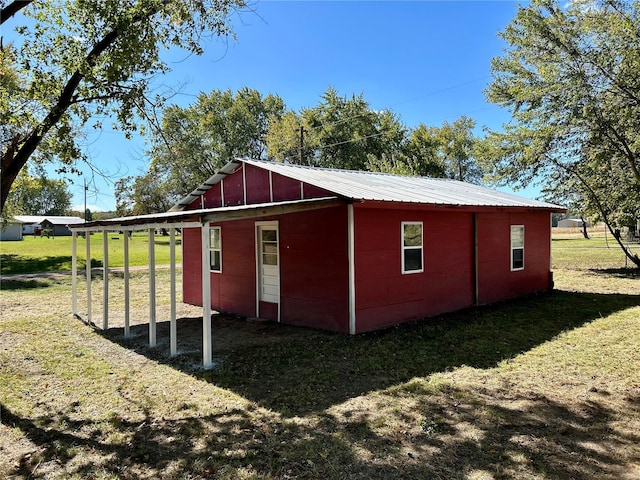 view of outbuilding with a yard