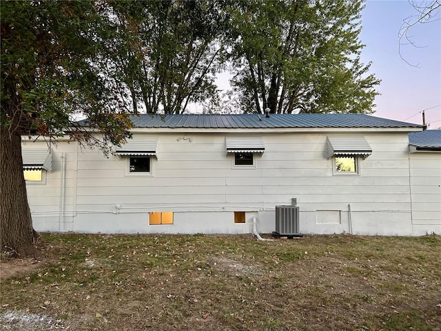 property exterior at dusk featuring cooling unit