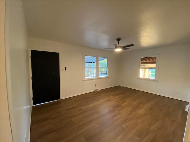 unfurnished room featuring dark hardwood / wood-style floors and ceiling fan