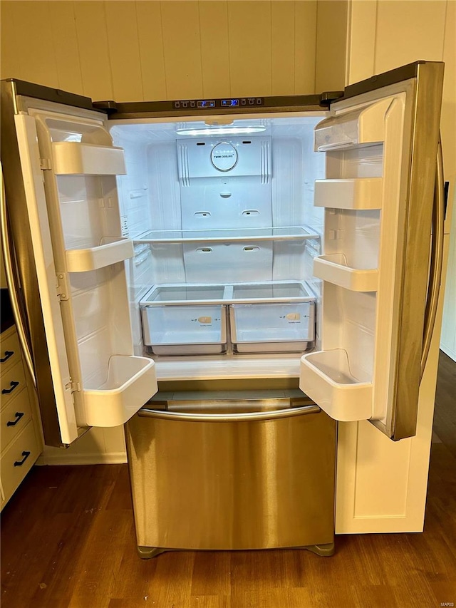 details with fridge and dark hardwood / wood-style flooring