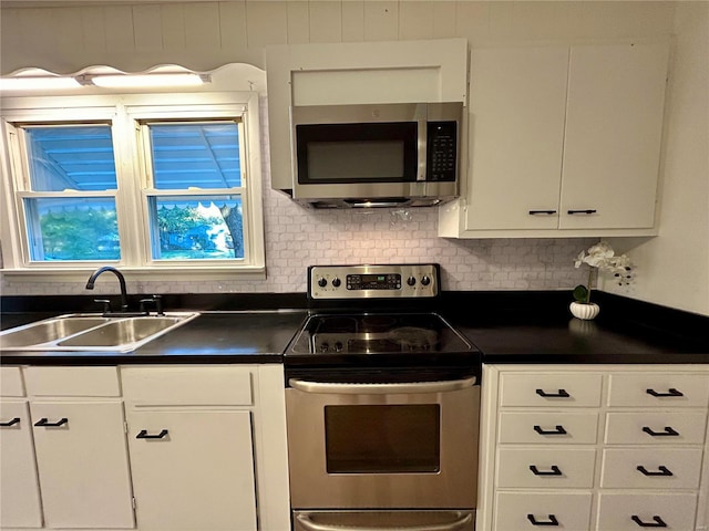 kitchen featuring sink, appliances with stainless steel finishes, white cabinets, and tasteful backsplash