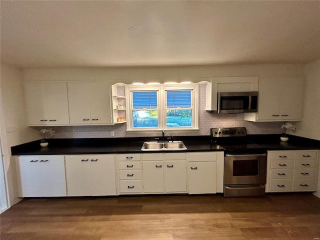 kitchen featuring white cabinets, hardwood / wood-style flooring, stainless steel appliances, and sink