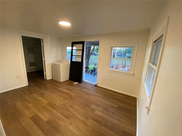 spare room with washer / clothes dryer and dark hardwood / wood-style floors