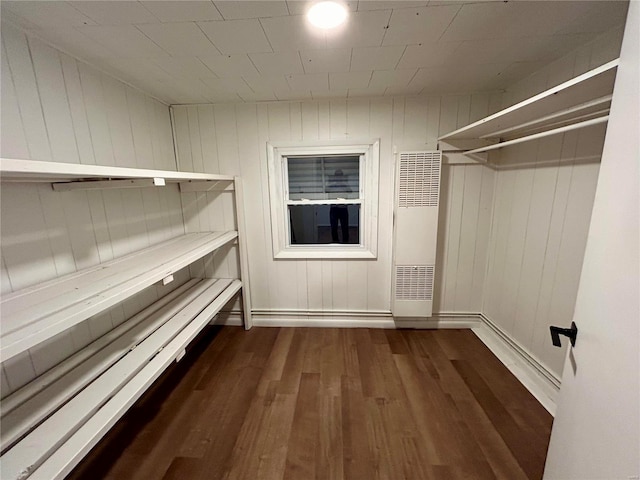 walk in closet with dark wood-type flooring