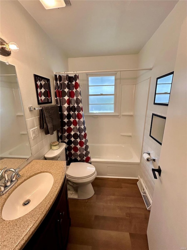 full bathroom with toilet, backsplash, hardwood / wood-style floors, vanity, and shower / bathtub combination with curtain