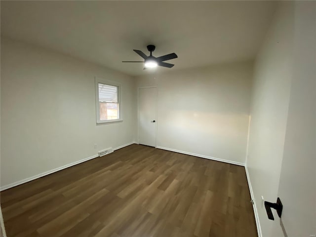 unfurnished room with dark hardwood / wood-style floors and ceiling fan