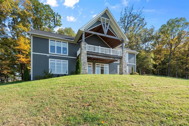 rear view of house featuring a yard