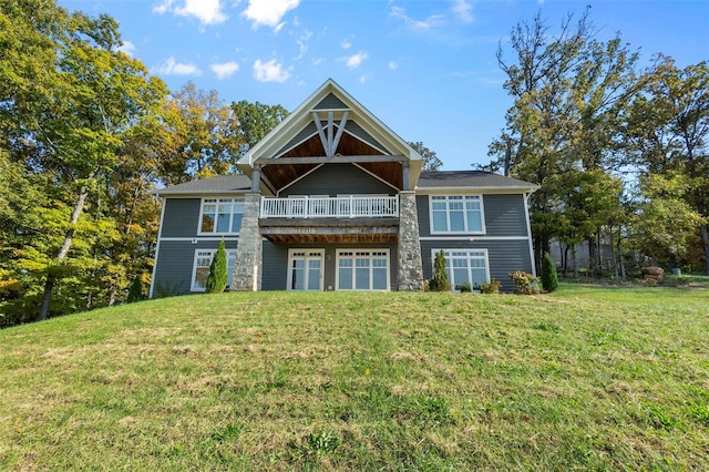 rear view of property featuring a lawn