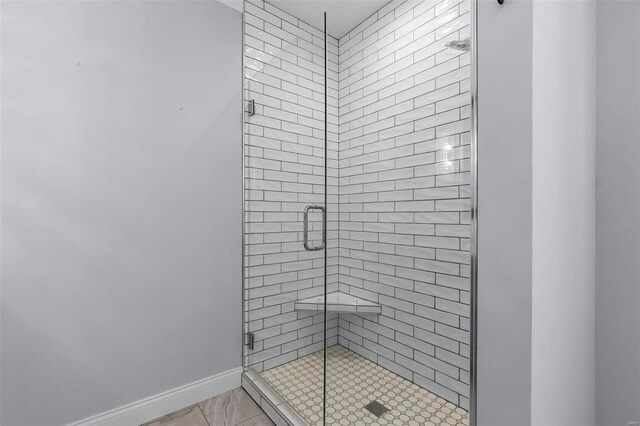 bathroom featuring a shower with door and tile patterned floors