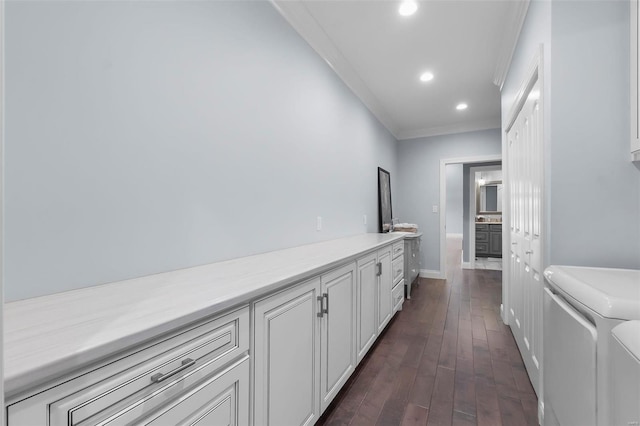 hall with crown molding, dark hardwood / wood-style floors, and washing machine and clothes dryer