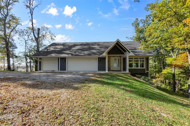 view of front of home featuring a front lawn and a garage