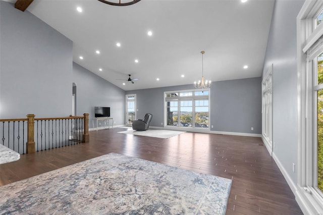 living room featuring high vaulted ceiling, ceiling fan with notable chandelier, and dark hardwood / wood-style flooring