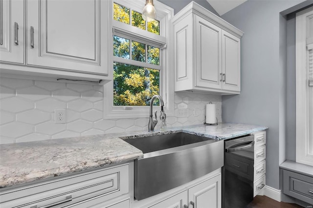 kitchen with sink, light stone countertops, tasteful backsplash, white cabinetry, and dark hardwood / wood-style flooring