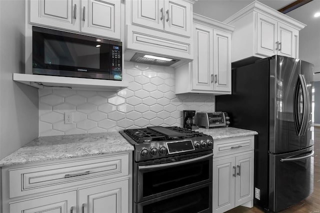 kitchen featuring dark wood-type flooring, appliances with stainless steel finishes, and white cabinets