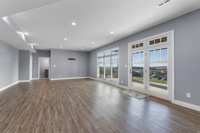 unfurnished living room with dark hardwood / wood-style flooring