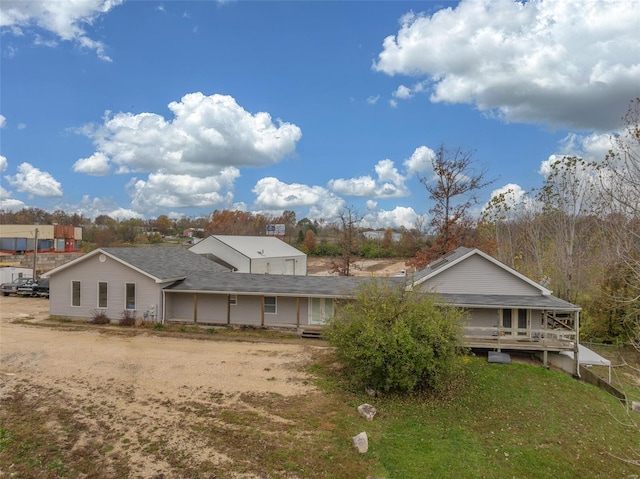 rear view of property with a yard