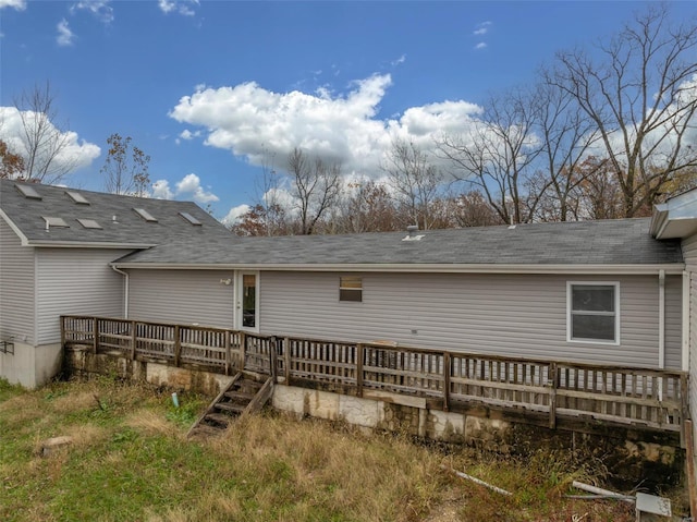 rear view of property featuring a deck