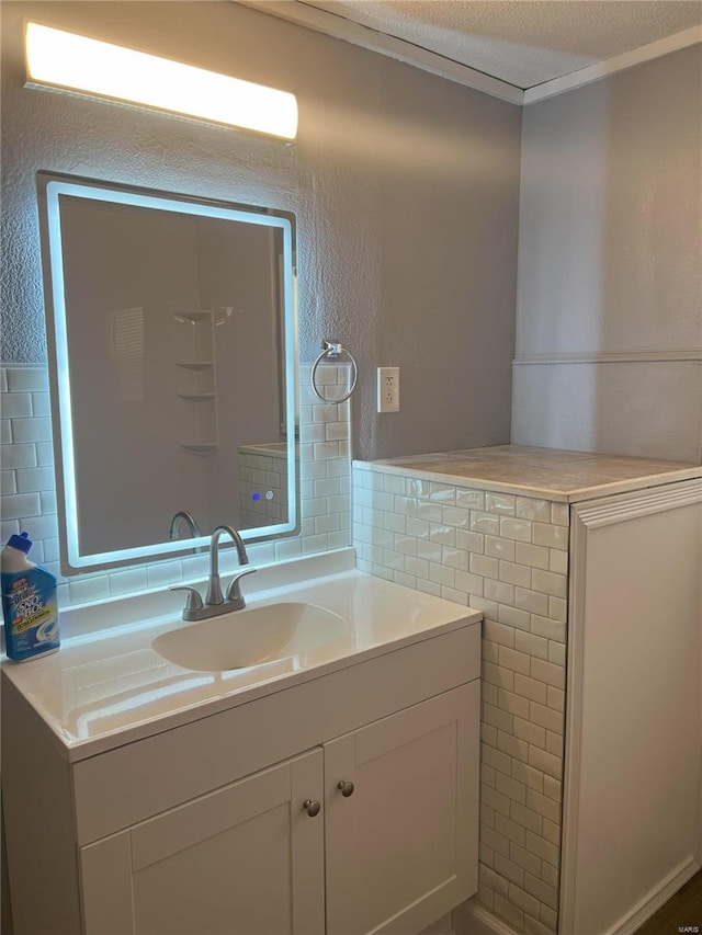 bathroom with tile walls, vanity, and a textured ceiling