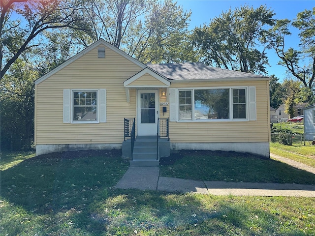 bungalow-style home with a front lawn