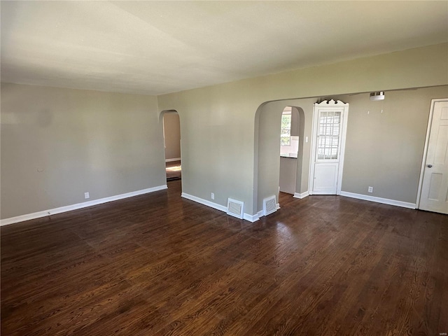 unfurnished room with dark wood-type flooring