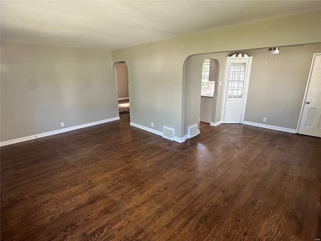 empty room with dark hardwood / wood-style flooring