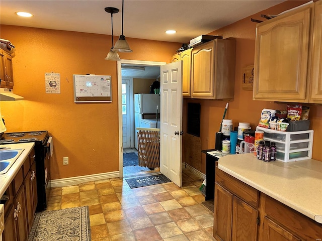 kitchen with hanging light fixtures, refrigerator, and black stove