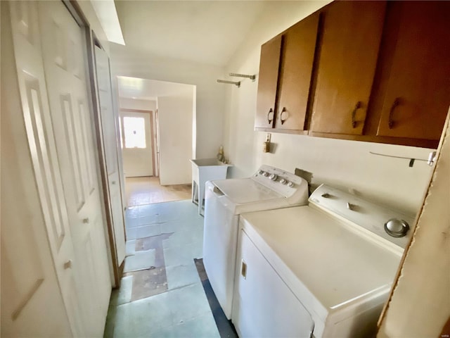 laundry room featuring independent washer and dryer, cabinets, and light tile patterned floors