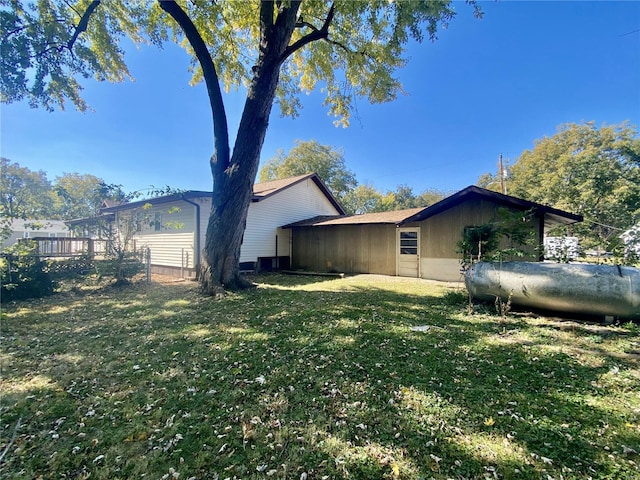 view of side of property with a lawn