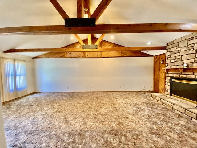 unfurnished living room with a stone fireplace, carpet flooring, and vaulted ceiling with beams