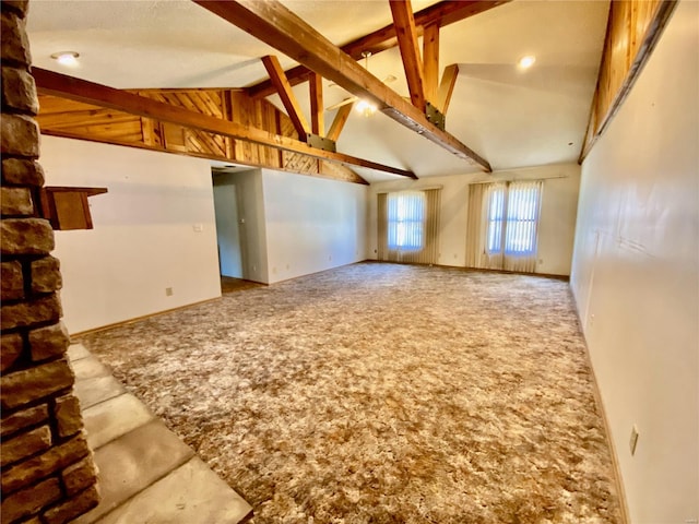 interior space with beamed ceiling, high vaulted ceiling, and carpet